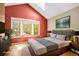 Comfortable bedroom with vaulted ceiling, skylight, hardwood floor, and natural light at 1209 S Flower Cir # C, Lakewood, CO 80232