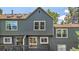 Exterior of home with wood deck and fenced backyard surrounded by mature trees at 1209 S Flower Cir # C, Lakewood, CO 80232
