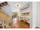 Hallway view of the kitchen with a light-filled desk area and hardwood floors at 1209 S Flower Cir # C, Lakewood, CO 80232