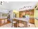 Open concept kitchen with island seating, wooden cabinets, and stainless steel refrigerator at 1209 S Flower Cir # C, Lakewood, CO 80232