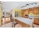 Bright kitchen featuring a center island, wooden cabinets, and stainless steel appliances at 1209 S Flower Cir # C, Lakewood, CO 80232