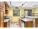 Well-lit kitchen features granite countertops, wooden cabinets, and a window with a view at 1209 S Flower Cir # C, Lakewood, CO 80232
