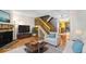 Inviting living room features a fireplace, hardwood floors, and a staircase leading to the upper level at 1209 S Flower Cir # C, Lakewood, CO 80232