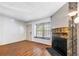 Bright living room showcasing hardwood floors, fireplace, and large window with natural light at 1209 S Flower Cir # C, Lakewood, CO 80232