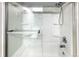 Bright shower with sliding glass door and molded shelving at 1209 S Flower Cir # C, Lakewood, CO 80232