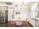 Cozy dining area with stylish pink chairs, a modern chandelier, and hardwood floors at 2773 Roslyn St, Denver, CO 80238