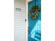 Bright blue front door adorned with a leafy green wreath and smart lock for easy access at 2773 Roslyn St, Denver, CO 80238