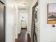 Hallway featuring an in-unit washer and dryer and access to other rooms in the home at 2773 Roslyn St, Denver, CO 80238