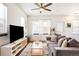 Comfortable living room with a large couch, stylish TV stand, and plenty of natural light at 2773 Roslyn St, Denver, CO 80238