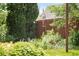 Lush backyard featuring vibrant greenery, colorful flowers, and a charming hummingbird feeder at 5044 W Moncrieff Pl, Denver, CO 80212