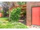 Cozy backyard patio featuring a pergola with climbing vines and a red brick structure at 5044 W Moncrieff Pl, Denver, CO 80212