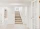 Finished basement with carpeted stairs, bathroom and glass door to bonus room at 5044 W Moncrieff Pl, Denver, CO 80212