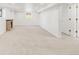 Spacious finished basement with stone fireplace, neutral carpet, and bright, clean feel at 5044 W Moncrieff Pl, Denver, CO 80212