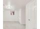 Finished basement with neutral carpet, storage, and ample space at 5044 W Moncrieff Pl, Denver, CO 80212