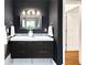 Modern bathroom features a double vanity, stylish lighting, and dark walls at 5044 W Moncrieff Pl, Denver, CO 80212