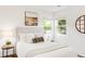 A bright bedroom featuring many windows and a comfortable bed at 5044 W Moncrieff Pl, Denver, CO 80212