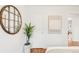 Bedroom showcases a round decorative mirror, plant, and artwork at 5044 W Moncrieff Pl, Denver, CO 80212