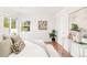 Bright bedroom with hardwood floors, neutral decor, and natural light from the window at 5044 W Moncrieff Pl, Denver, CO 80212