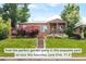 Charming brick home featuring a cozy front porch and beautifully landscaped front yard, perfect for outdoor enjoyment at 5044 W Moncrieff Pl, Denver, CO 80212