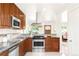Modern kitchen with stainless steel appliances, granite countertops, and wood cabinets at 5044 W Moncrieff Pl, Denver, CO 80212