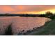 Calm lake view at sunset with warm colors reflecting on the water at 5044 W Moncrieff Pl, Denver, CO 80212