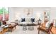 Bright living room with hardwood floors, modern furniture, and an open layout at 5044 W Moncrieff Pl, Denver, CO 80212