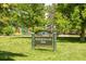 Pferdesteller Park sign with lush green grass, mature trees, and playground equipment in the background at 5044 W Moncrieff Pl, Denver, CO 80212