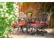 Charming patio setup with elegant wrought iron furniture and vibrant flower arrangement at 5044 W Moncrieff Pl, Denver, CO 80212