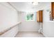 Storage area with wall-mounted shelving, laundry, and window at 5044 W Moncrieff Pl, Denver, CO 80212
