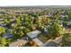 A sprawling view of a neighborhood with mature trees, showcasing the property's location and surroundings at 5054 W 61St Dr, Arvada, CO 80003