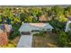 Overhead view of a single-story home with a spacious driveway, lush green trees, and a well-kept lawn at 5054 W 61St Dr, Arvada, CO 80003