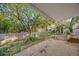 Covered back patio overlooking spacious yard with mature trees and landscaping at 5054 W 61St Dr, Arvada, CO 80003