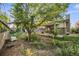 View of the house and yard featuring mature landscaping and partially covered patio at 5054 W 61St Dr, Arvada, CO 80003