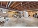 Unfinished basement with exposed beams, utilities, and ample storage space at 5054 W 61St Dr, Arvada, CO 80003