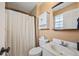 Cozy bathroom features shower with patterned curtain and vanity with mirror at 5054 W 61St Dr, Arvada, CO 80003