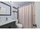 Neat bathroom featuring a vanity, toilet, and a shower with patterned curtain at 5054 W 61St Dr, Arvada, CO 80003