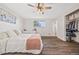 Charming bedroom offers wood-look flooring, fan, natural light, and closet at 5054 W 61St Dr, Arvada, CO 80003