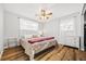 Comfortable bedroom boasts wood-look floors, ceiling fan, and plenty of light at 5054 W 61St Dr, Arvada, CO 80003