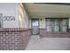 Charming front porch with brick accents, stylish windows, and a welcoming entrance, creating a warm and inviting curb appeal at 5054 W 61St Dr, Arvada, CO 80003