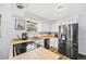 Bright kitchen with stainless steel appliances, wood countertops, and a window over the sink at 5054 W 61St Dr, Arvada, CO 80003