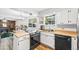 Cozy kitchen with modern appliances, wood countertops, and an adjacent dining area at 5054 W 61St Dr, Arvada, CO 80003