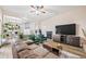Spacious living room with stylish furniture and an open view into the kitchen and dining area at 5054 W 61St Dr, Arvada, CO 80003