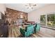 Charming living room features a brick fireplace, stylish furniture, and sliding glass doors to the outside at 5054 W 61St Dr, Arvada, CO 80003