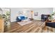 Bright living room with hardwood floors, a comfortable blue sofa, and abundant natural light, perfect for relaxation at 5054 W 61St Dr, Arvada, CO 80003