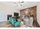 Comfortable living room with a brick fireplace, stylish furniture, and ample natural light at 5054 W 61St Dr, Arvada, CO 80003