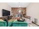 Inviting living room featuring a brick fireplace and comfortable seating arrangement at 5054 W 61St Dr, Arvada, CO 80003