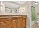 Well-lit bathroom with a double sink vanity, wood cabinetry and a shower at 1365 Columbine St # 403, Denver, CO 80206