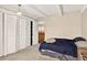 Bedroom showcasing built-in closets and neutral carpet leading to an en suite bathroom at 1365 Columbine St # 403, Denver, CO 80206