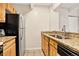 Efficient kitchen featuring wood cabinets, granite countertops, and modern appliances at 1365 Columbine St # 403, Denver, CO 80206