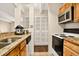 Functional kitchen with granite countertops, white appliances, and ample storage space at 1365 Columbine St # 403, Denver, CO 80206